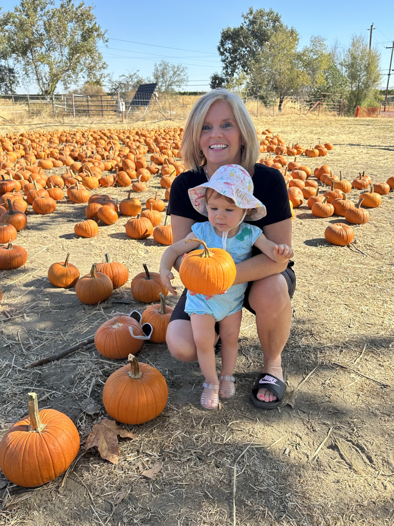 Becca with her grandmother and a pumpkin patch